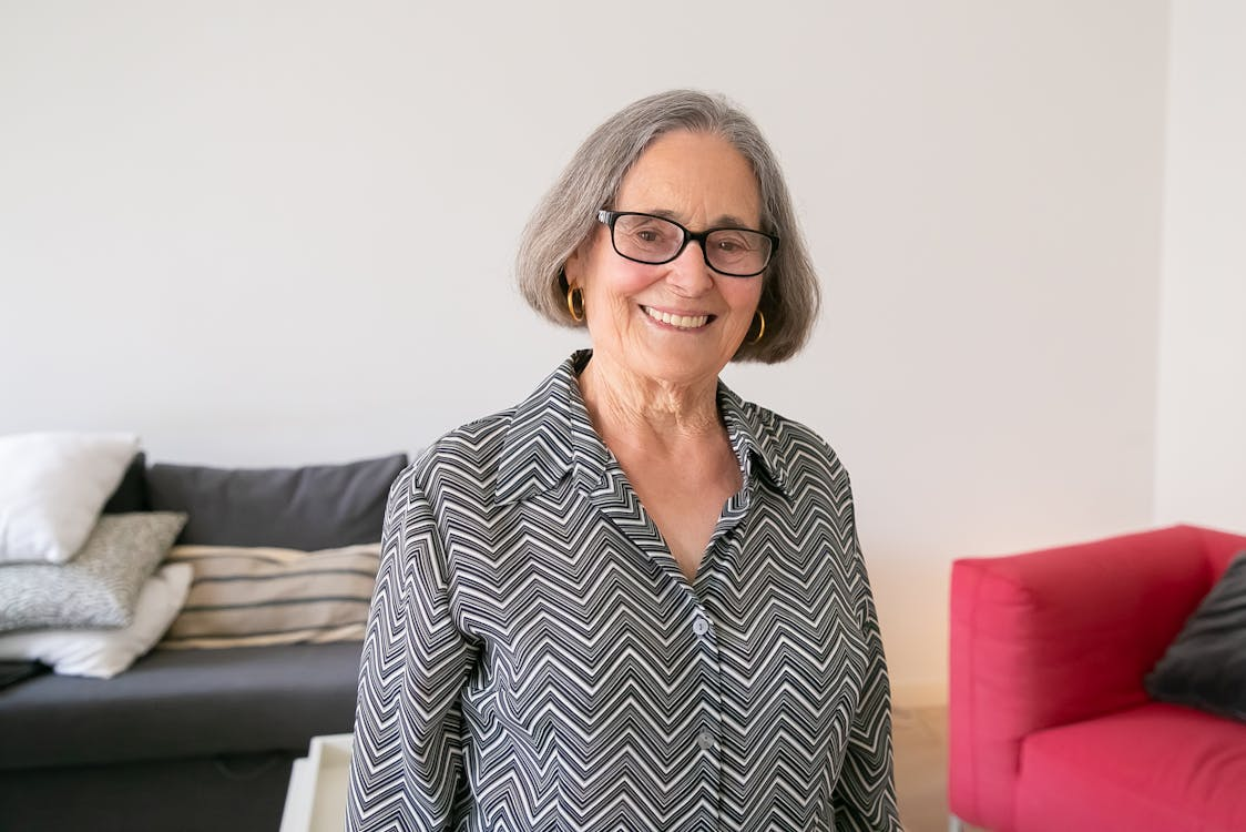 A smiling person with glasses