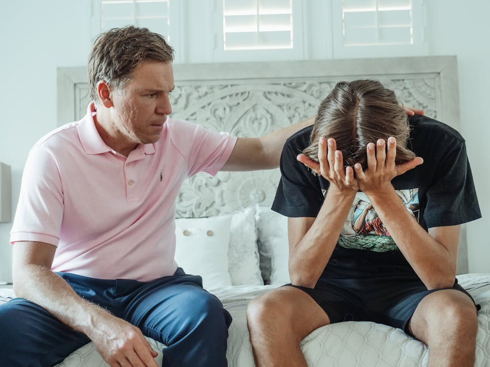 A guardian consoling a distraught teenager