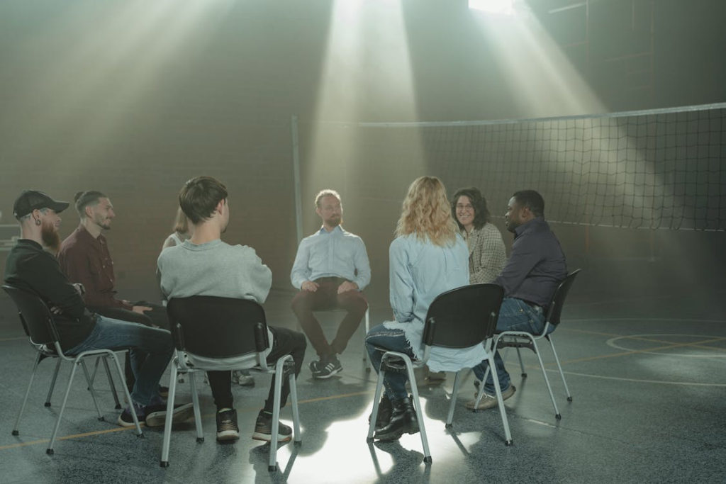a group of people sitting on chairs for counseling