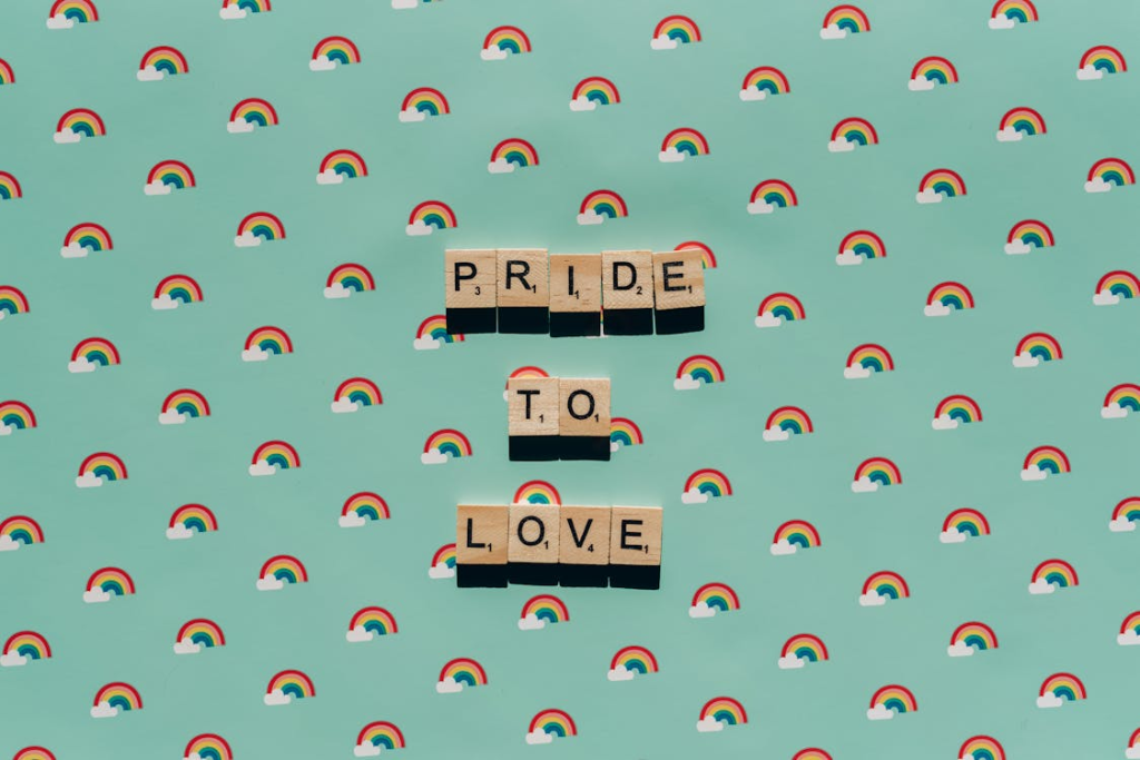 Scrabble tiles spelling ‘pride to love.’