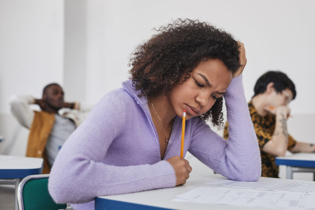 A stressed person holding a pencil