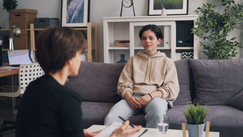 First-year college student discussing challenges related to moving away from home during a therapy session
