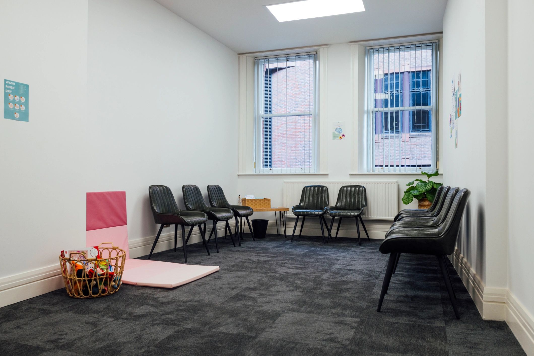 Calm, welcoming waiting area with seating and a children’s play space