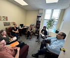 Alternative Therapy team collaborating in a bright office workspace