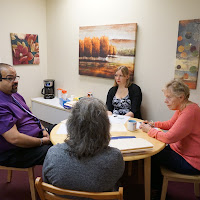 Alternative Therapy team meeting together around a table