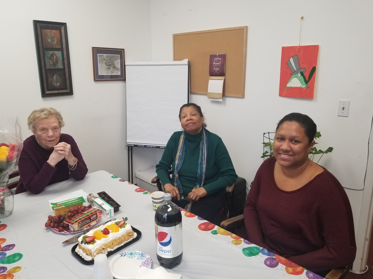 Alternative Therapy team members celebrating at a table