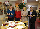 Alternative Therapy team celebrating together at a decorated table